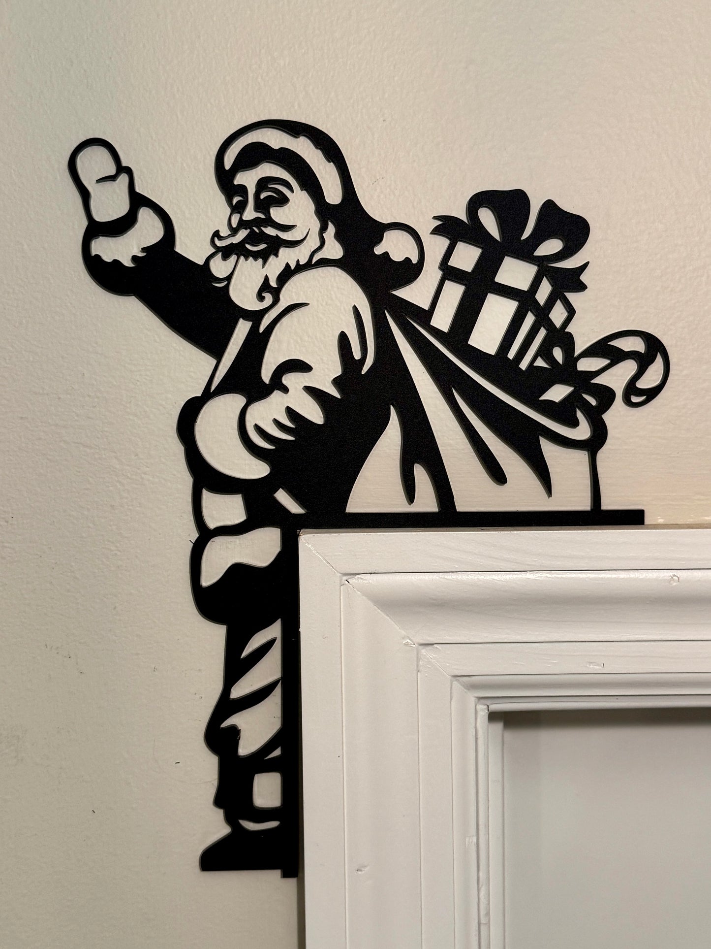 Decorative acyrlic cutout of Santa Claus to hang on a corner of a door